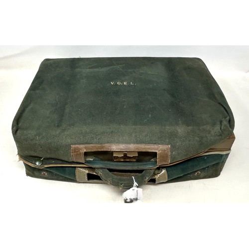 988 - An Art Deco travelling dressing case, the glass jars with enamel decoration, in a green leather trav... 