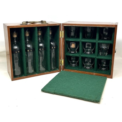 1144 - An early 20th century mahogany travelling tantalus, with four original bottles, and twelve non match... 