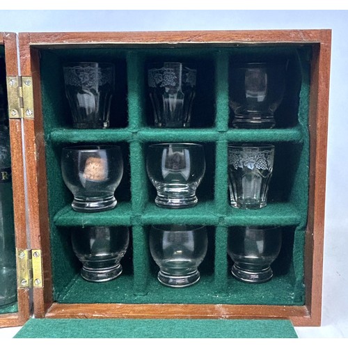 1144 - An early 20th century mahogany travelling tantalus, with four original bottles, and twelve non match... 