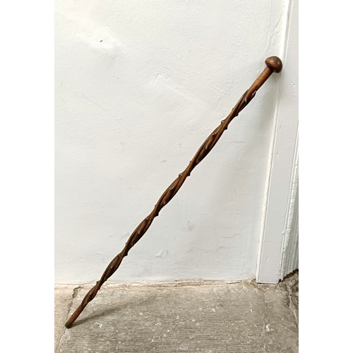 1110 - A folk art carved wooden walking stick, in the form of a twisted branch, 87 cm Provenance: Part of a... 