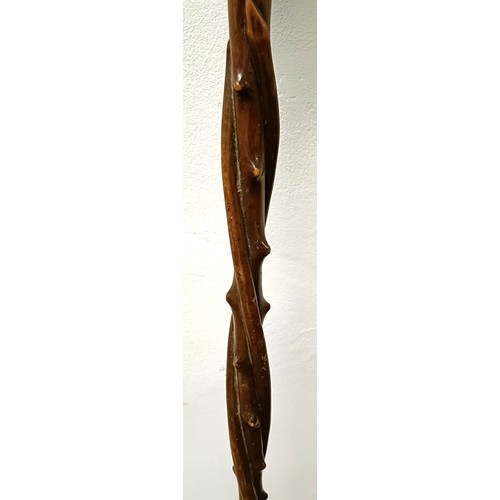 1110 - A folk art carved wooden walking stick, in the form of a twisted branch, 87 cm Provenance: Part of a... 