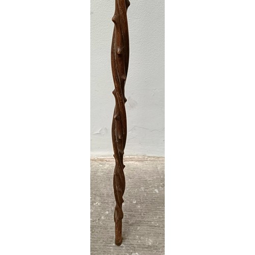 1110 - A folk art carved wooden walking stick, in the form of a twisted branch, 87 cm Provenance: Part of a... 