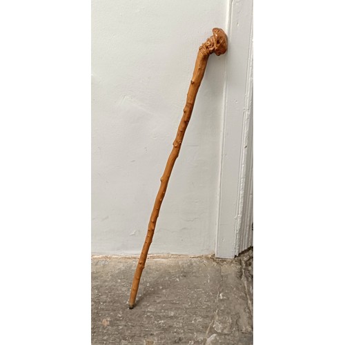 1127 - A folk art walking stick, handle carved in the form of a man wearing a hat, 90 cm Provenance: Part o... 