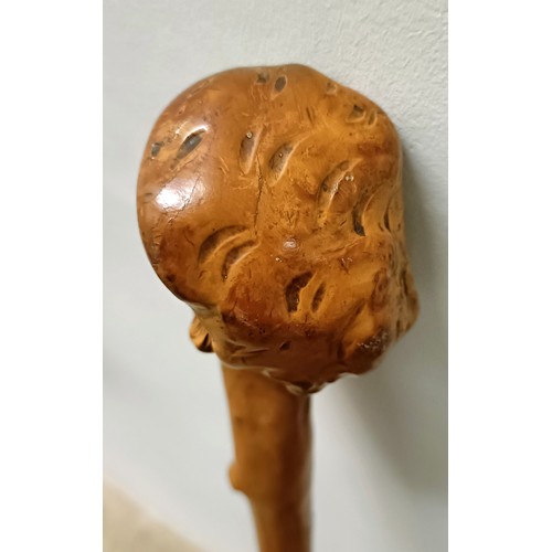 1127 - A folk art walking stick, handle carved in the form of a man wearing a hat, 90 cm Provenance: Part o... 