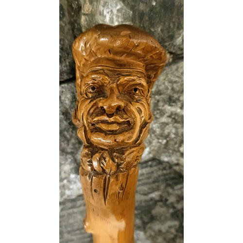 1127 - A folk art walking stick, handle carved in the form of a man wearing a hat, 90 cm Provenance: Part o... 