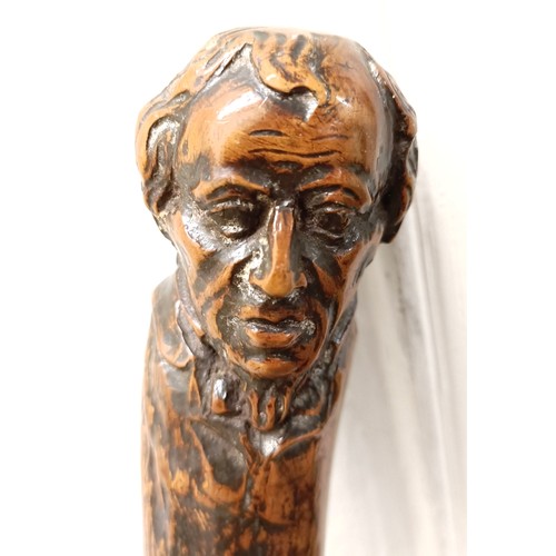 1128 - A folk art walking stick, handle carved in the form of a man's head, 92 cm Provenance: Part of a sin... 