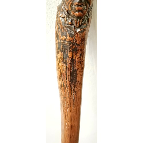 1128 - A folk art walking stick, handle carved in the form of a man's head, 92 cm Provenance: Part of a sin... 