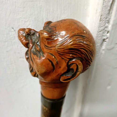 1129 - An early 20th century novelty walking stick, with a carved handle, in the form of a grotesque man, w... 