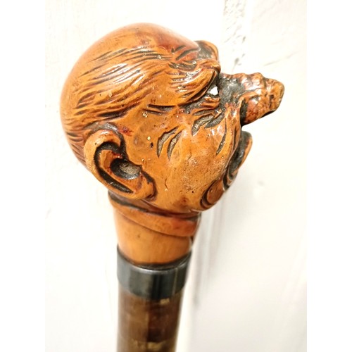 1129 - An early 20th century novelty walking stick, with a carved handle, in the form of a grotesque man, w... 