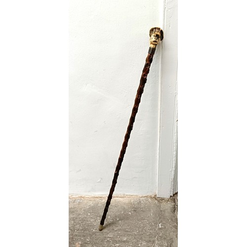 1134 - A novelty walking stick, with a carved antler handle, in the form of a bulldog, with a sterling silv... 