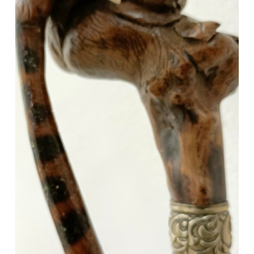 1138 - An early 20th century, novelty walking stick, with a carved bamboo handle decorated animals, inset w... 