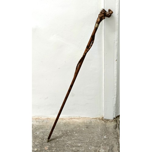 1138 - An early 20th century, novelty walking stick, with a carved bamboo handle decorated animals, inset w... 