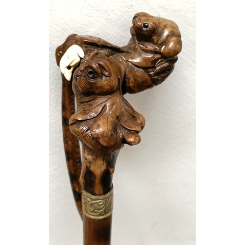 1138 - An early 20th century, novelty walking stick, with a carved bamboo handle decorated animals, inset w... 