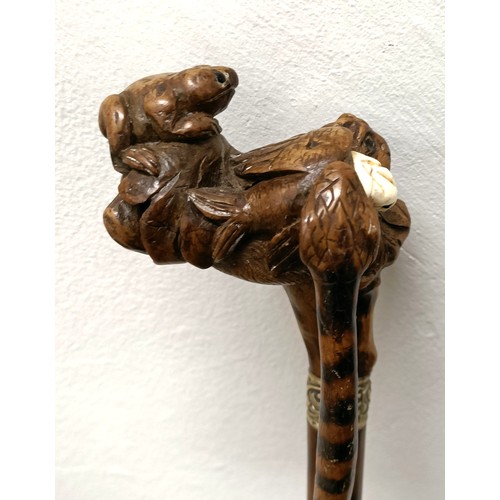 1138 - An early 20th century, novelty walking stick, with a carved bamboo handle decorated animals, inset w... 