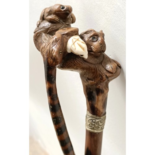 1138 - An early 20th century, novelty walking stick, with a carved bamboo handle decorated animals, inset w... 