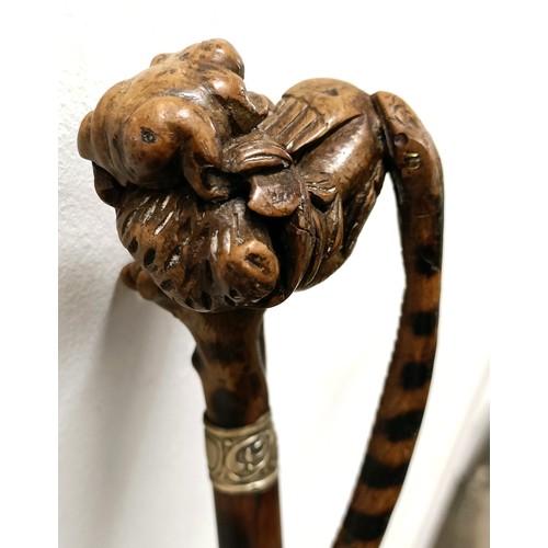 1138 - An early 20th century, novelty walking stick, with a carved bamboo handle decorated animals, inset w... 