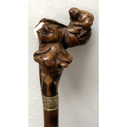 1138 - An early 20th century, novelty walking stick, with a carved bamboo handle decorated animals, inset w... 