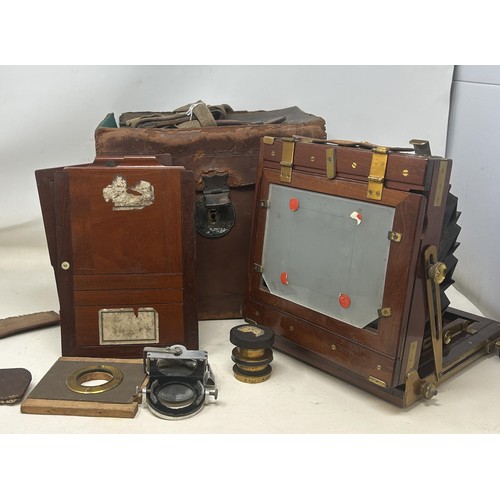 872 - A late 19th century early 20th century plate camera, in a leather case