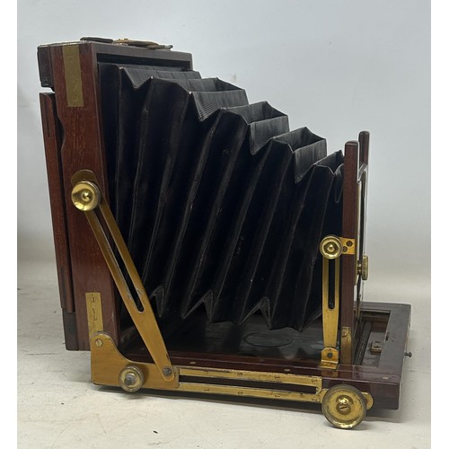 872 - A late 19th century early 20th century plate camera, in a leather case