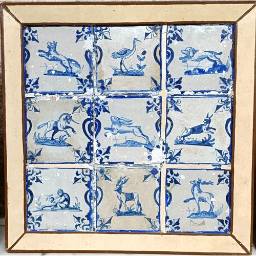 1009 - A set of nine Dutch Delft tiles, framed as one, decorated animals, 39 x 38.5 cm