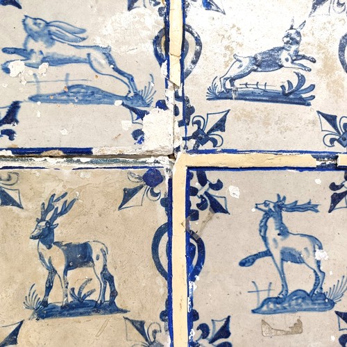 1009 - A set of nine Dutch Delft tiles, framed as one, decorated animals, 39 x 38.5 cm