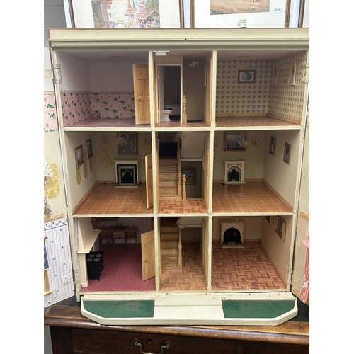 249 - A modern dolls house, 70 cm wide and assorted dolls house furniture