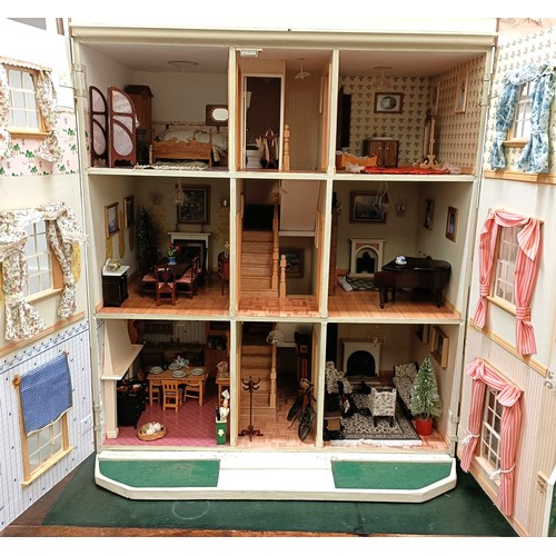 249 - A modern dolls house, 70 cm wide and assorted dolls house furniture