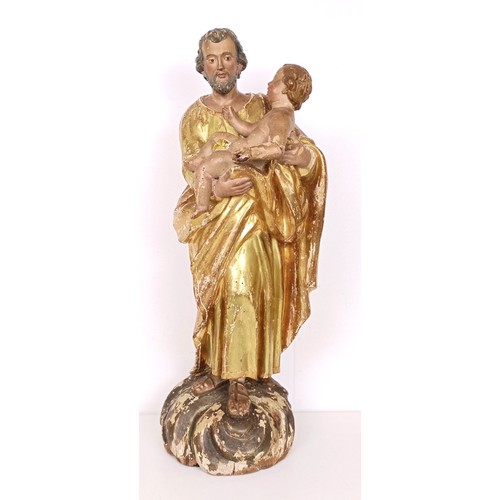 802 - A carved giltwood and polychrome group of St Joseph holding the infant Jesus, 57 cm high