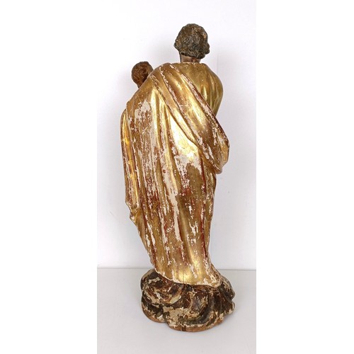 802 - A carved giltwood and polychrome group of St Joseph holding the infant Jesus, 57 cm high