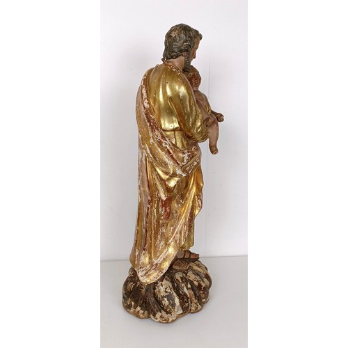 802 - A carved giltwood and polychrome group of St Joseph holding the infant Jesus, 57 cm high