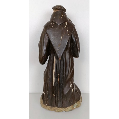 803 - A carved polychrome group of St Anthony holding the infant Jesus, 51 cm high