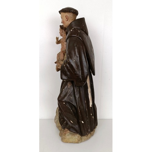 803 - A carved polychrome group of St Anthony holding the infant Jesus, 51 cm high