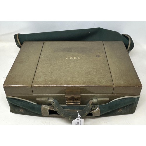 844 - An Art Deco travelling dressing case, the glass jars with enamel decoration, in a green leather trav... 