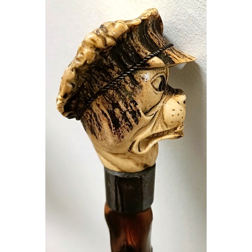 772 - A novelty walking stick, with a carved antler handle, in the form of a bulldog, with a sterling silv... 