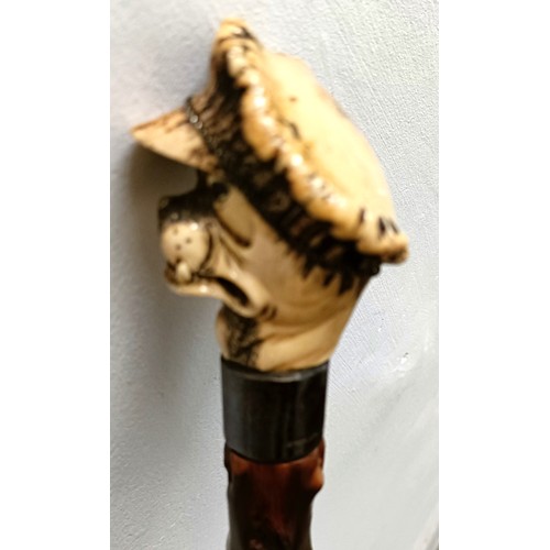 772 - A novelty walking stick, with a carved antler handle, in the form of a bulldog, with a sterling silv... 