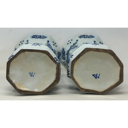 719 - A pair of Delft vases, 33 cm high, and a Delft plate, 37 cm high (3)
