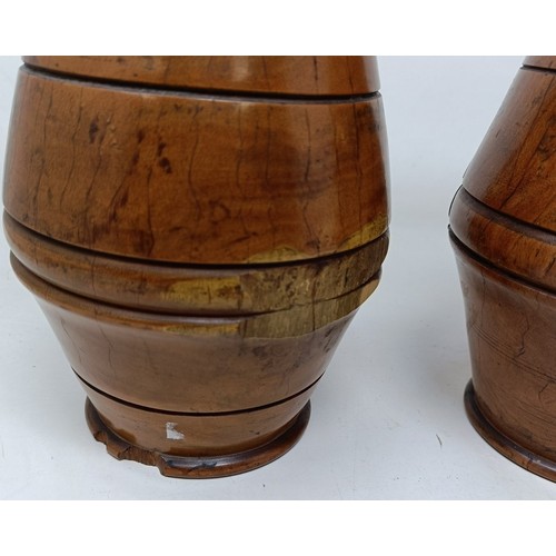717 - A pair of turned lignum vitae urns and cover, 30 cm high (2)