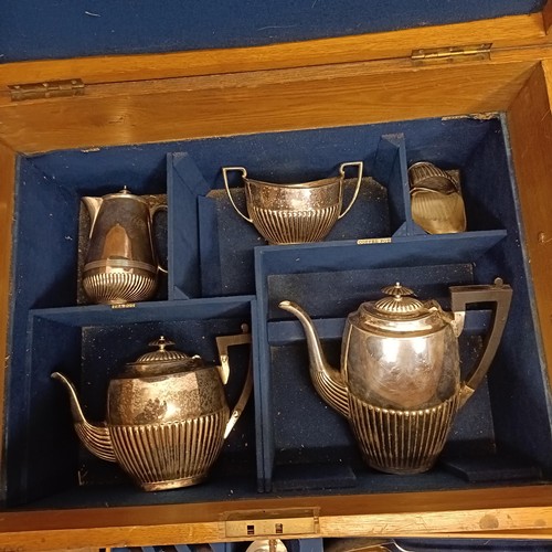 819 - A canteen of cutlery, in an oak case, with a four piece tea service