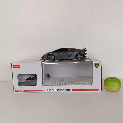 59 - A radio controlled Bentley Continental GT car, a similar Lamborghini, Jaguar calendars and posters (... 