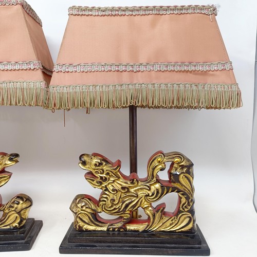 779 - A pair of carved wooden table lamps, based on the form of Dogs of Fo, 36 cm