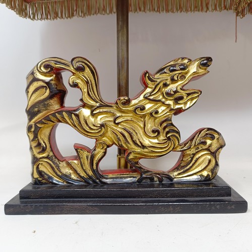 779 - A pair of carved wooden table lamps, based on the form of Dogs of Fo, 36 cm