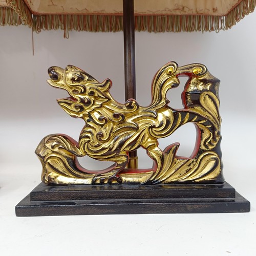 779 - A pair of carved wooden table lamps, based on the form of Dogs of Fo, 36 cm