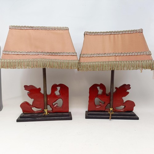 779 - A pair of carved wooden table lamps, based on the form of Dogs of Fo, 36 cm
