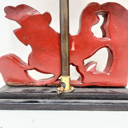 779 - A pair of carved wooden table lamps, based on the form of Dogs of Fo, 36 cm
