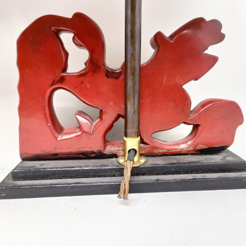 779 - A pair of carved wooden table lamps, based on the form of Dogs of Fo, 36 cm