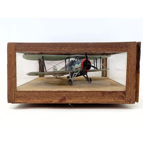 778 - A model of an RAF bi-plane, in a glass case, 19 cm wide