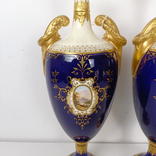 875 - A pair of early 20th century Coalport vases, the deep blue grounds with central cartouches, decorate... 