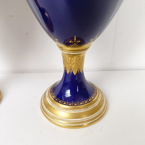 875 - A pair of early 20th century Coalport vases, the deep blue grounds with central cartouches, decorate... 