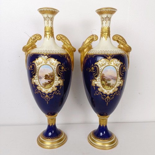 875 - A pair of early 20th century Coalport vases, the deep blue grounds with central cartouches, decorate... 