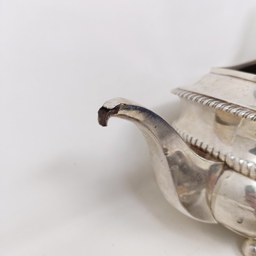 877 - A George III silver teapot, a cut glass match strike, with a silver mount, a silver plated tea strai... 
